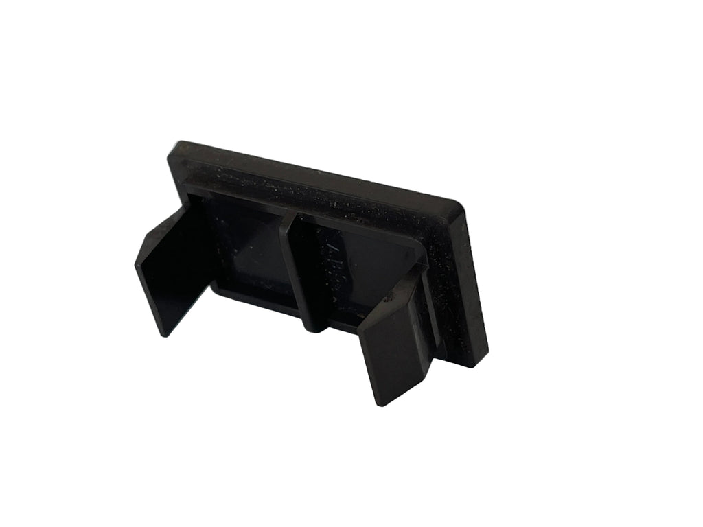 A small black plastic clip or bracket with a rectangular backplate and two angled side tabs, photographed on a plain light surface.