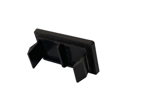 A small black plastic clip or bracket with a rectangular backplate and two angled side tabs, photographed on a plain light surface.