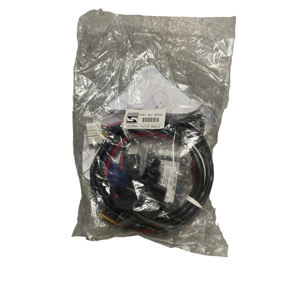 A packaged black cable assembly with multiple connectors, sealed in a clear plastic bag, placed on a gray speckled floor. Hayman Reese Trailer Harnes universal 